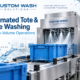 Automated tote and crate washing system cleaning reusable blue containers in a high-volume industrial facility.
